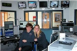 Two dispatchers standing in Public Communications office
